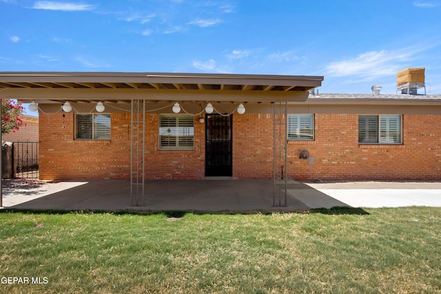 8213 Mineola Dr, El Paso, TX 79925 - rear view of house featuring a patio and brick siding
