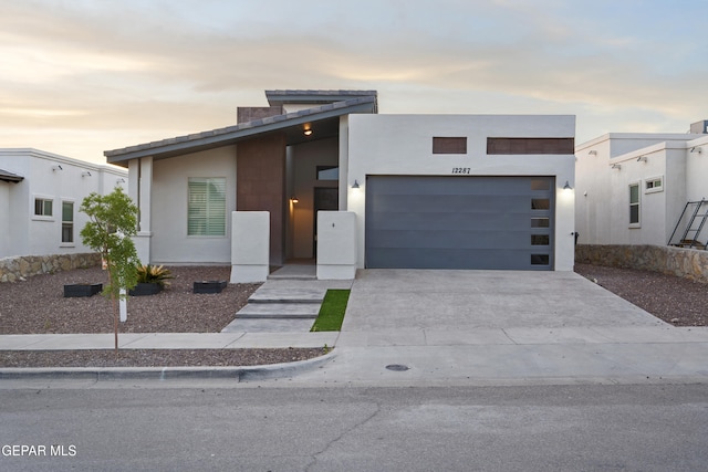 12287 Houghton Spgs, Horizon City, TX 79928 - contemporary house featuring driveway, a garage, and stucco siding