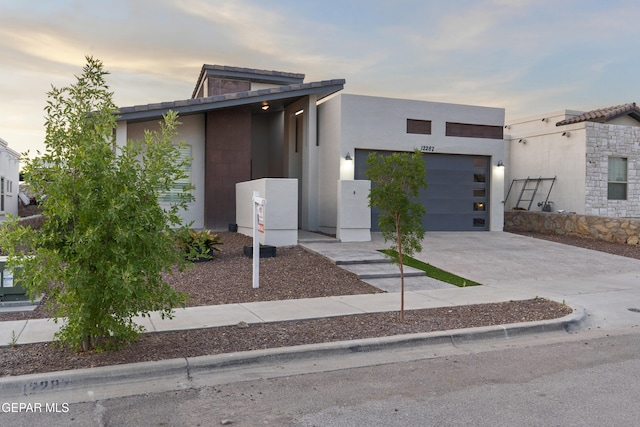 12287 Houghton Spgs, Horizon City, TX 79928 - contemporary home with concrete driveway, a garage, and stucco siding