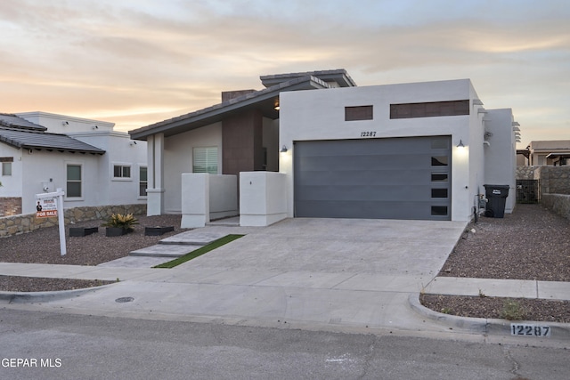 12287 Houghton Spgs, Horizon City, TX 79928 - contemporary house featuring driveway, an attached garage, and stucco siding