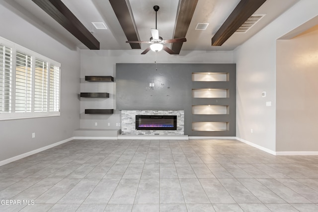 12287 Houghton Spgs, Horizon City, TX 79928 - unfurnished living room with a ceiling fan, tile patterned flooring, built in features, beam ceiling, and a glass covered fireplace