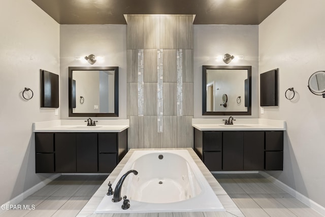 12287 Houghton Spgs, Horizon City, TX 79928 - bathroom featuring a tub with jets, two vanities, and baseboards