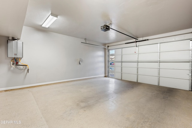 12287 Houghton Spgs, Horizon City, TX 79928 - garage featuring a garage door opener, baseboards, and tankless water heater