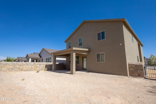 12301 Desert Heights Ct, El Paso, TX 79938 - back of house featuring stucco siding and a patio area