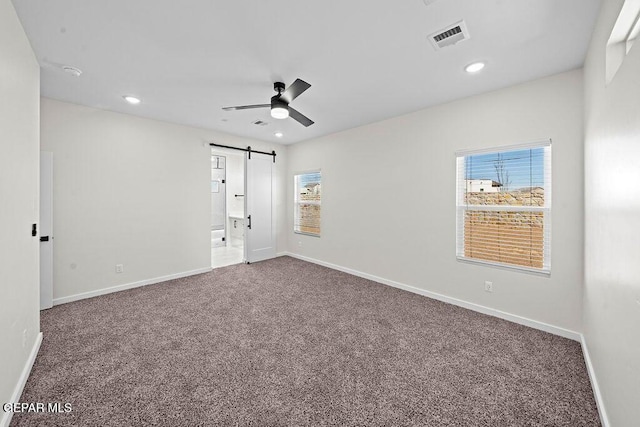 13391 Jeff Winton Dr, El Paso, TX 79928 - carpeted empty room with a barn door, a ceiling fan, plenty of natural light, baseboards, and recessed lighting