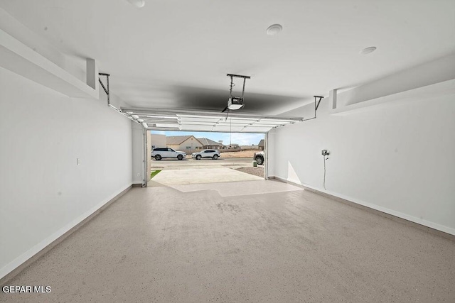 13391 Jeff Winton Dr, El Paso, TX 79928 - garage featuring a garage door opener and baseboards
