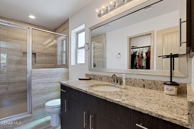 533 Cedarwood Ave, El Paso, TX 79928 - bathroom featuring vanity, toilet, a stall shower, and healthy amount of natural light