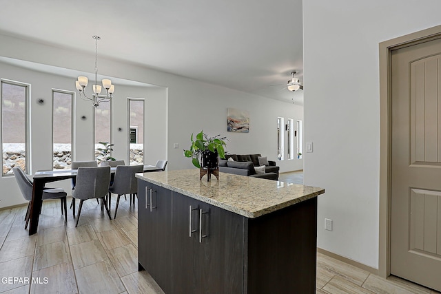 533 Cedarwood Ave, El Paso, TX 79928 - kitchen with a center island, ceiling fan, a chandelier, pendant lighting, and light stone counters