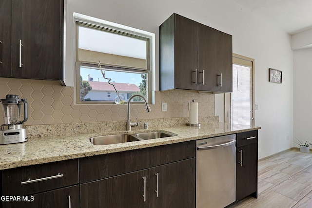 533 Cedarwood Ave, El Paso, TX 79928 - kitchen featuring stainless steel dishwasher, a sink, dark brown cabinets, decorative backsplash, and light stone counters
