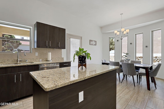 533 Cedarwood Ave, El Paso, TX 79928 - kitchen featuring a sink, stainless steel dishwasher, tasteful backsplash, a chandelier, and healthy amount of natural light