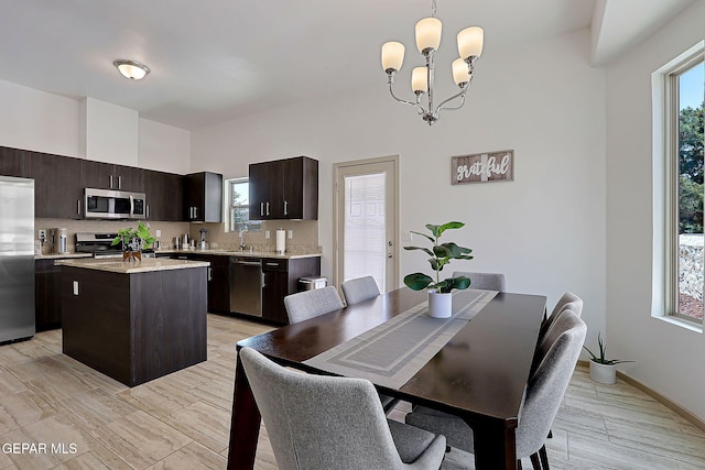 533 Cedarwood Ave, El Paso, TX 79928 - dining space featuring a chandelier, baseboards, and light wood-type flooring
