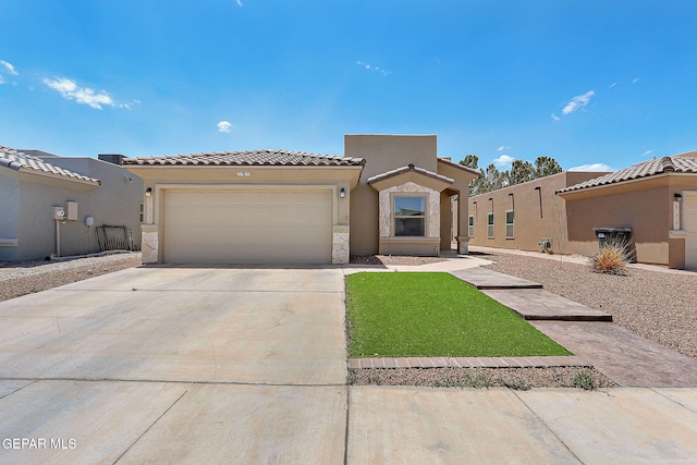 533 Cedarwood Ave, El Paso, TX 79928 - view of front facade with a garage, driveway, stucco siding, a tiled roof, and a front yard