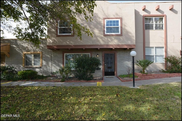 212 Paso Noble Dr, El Paso, TX 79912 - townhome / multi-family property with a front lawn and stucco siding