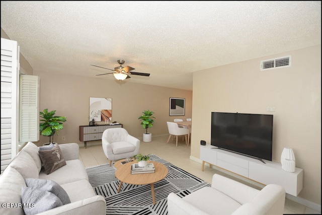 212 Paso Noble Dr, El Paso, TX 79912 - living room with a textured ceiling, ceiling fan, light tile patterned floors, and baseboards