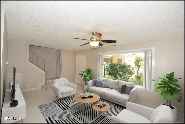 212 Paso Noble Dr, El Paso, TX 79912 - living room with stairs, a textured ceiling, ceiling fan, and tile patterned flooring
