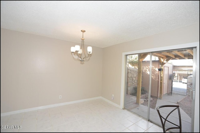 212 Paso Noble Dr, El Paso, TX 79912 - empty room with a chandelier, a textured ceiling, and baseboards