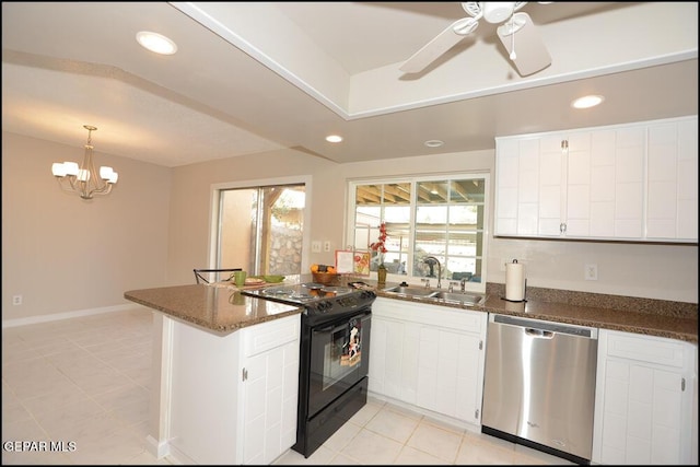 212 Paso Noble Dr, El Paso, TX 79912 - kitchen with stainless steel dishwasher, a sink, black electric range oven, a peninsula, and light tile patterned floors
