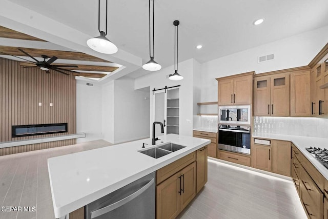 13399 Jeff Winton Dr, El Paso, TX 79928 - kitchen with appliances with stainless steel finishes, a sink, a barn door, ceiling fan, and open shelves
