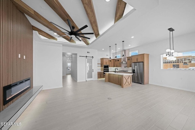 13399 Jeff Winton Dr, El Paso, TX 79928 - unfurnished living room with a barn door, a sink, a ceiling fan, a chandelier, and beamed ceiling