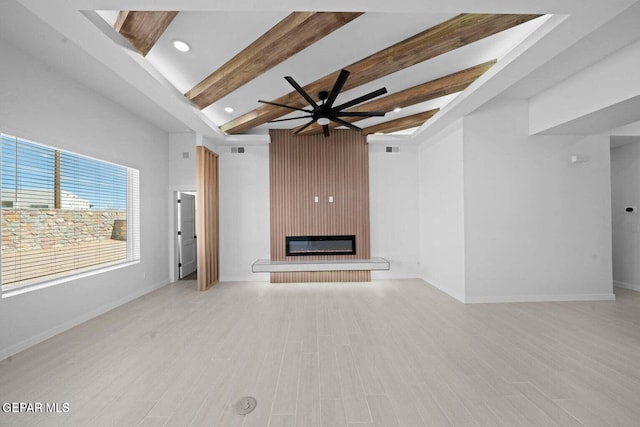 13399 Jeff Winton Dr, El Paso, TX 79928 - unfurnished living room featuring a large fireplace, beamed ceiling, a ceiling fan, light wood finished floors, and recessed lighting