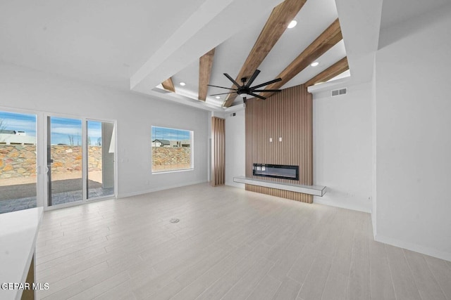 13399 Jeff Winton Dr, El Paso, TX 79928 - unfurnished living room featuring a glass covered fireplace, a ceiling fan, baseboards, beamed ceiling, and wood finished floors