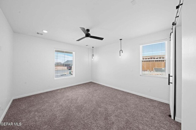 13399 Jeff Winton Dr, El Paso, TX 79928 - empty room with carpet floors, a ceiling fan, baseboards, a barn door, and recessed lighting