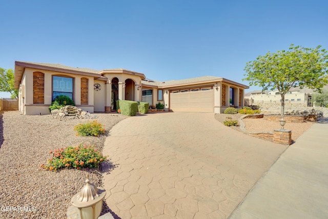 7301 Brays Landing Dr, El Paso, TX 79911 - view of front of home featuring a garage, concrete driveway, and stucco siding