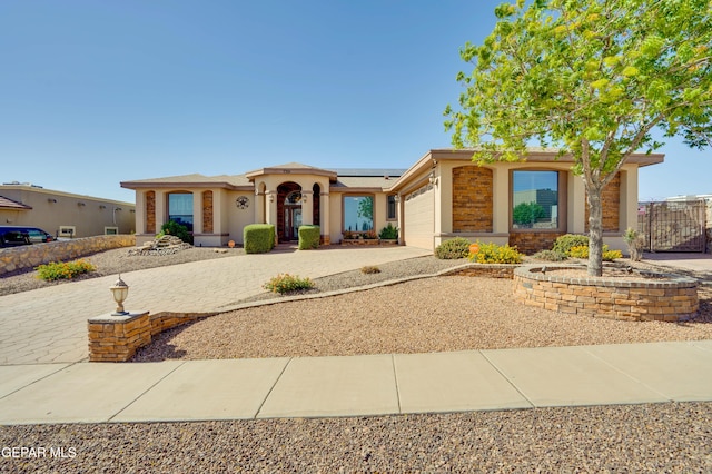 7301 Brays Landing Dr, El Paso, TX 79911 - mediterranean / spanish-style house with driveway, a garage, solar panels, and stucco siding