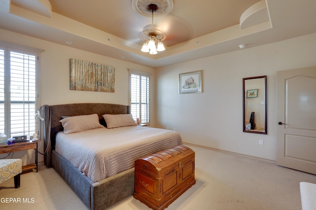 7301 Brays Landing Dr, El Paso, TX 79911 - bedroom featuring light colored carpet, a raised ceiling, and ceiling fan