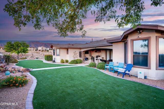 7301 Brays Landing Dr, El Paso, TX 79911 - yard at dusk with a yard and a patio area