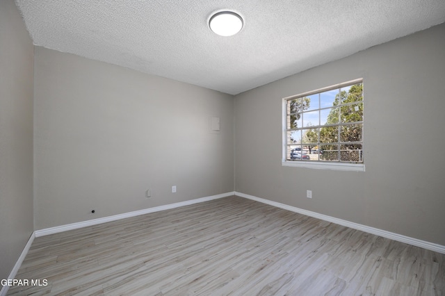 10704 Quartz St, El Paso, TX 79924 - spare room featuring light wood-style flooring, a textured ceiling, and baseboards