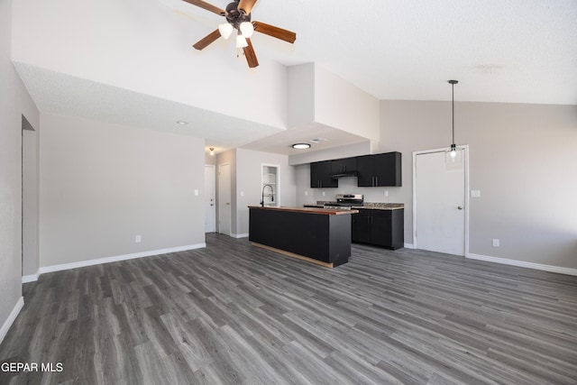 10704 Quartz St, El Paso, TX 79924 - kitchen featuring open floor plan, high vaulted ceiling, stainless steel stove, a ceiling fan, and dark cabinetry