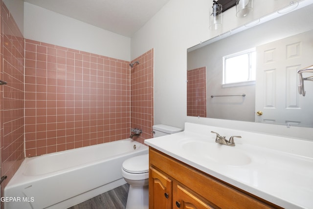 10704 Quartz St, El Paso, TX 79924 - full bathroom featuring toilet, vanity, shower / bathtub combination, and wood finished floors