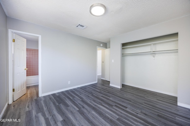 10704 Quartz St, El Paso, TX 79924 - unfurnished bedroom with dark wood-style floors, a closet, a textured ceiling, baseboards, and ensuite bathroom