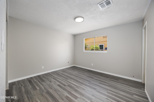 10704 Quartz St, El Paso, TX 79924 - spare room with dark wood finished floors, baseboards, and a textured ceiling