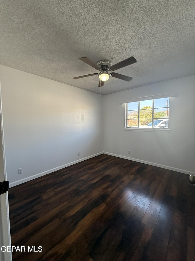 6220 Bel Mar Ave, El Paso, TX 79912 - spare room with a textured ceiling, dark wood-type flooring, ceiling fan, and baseboards