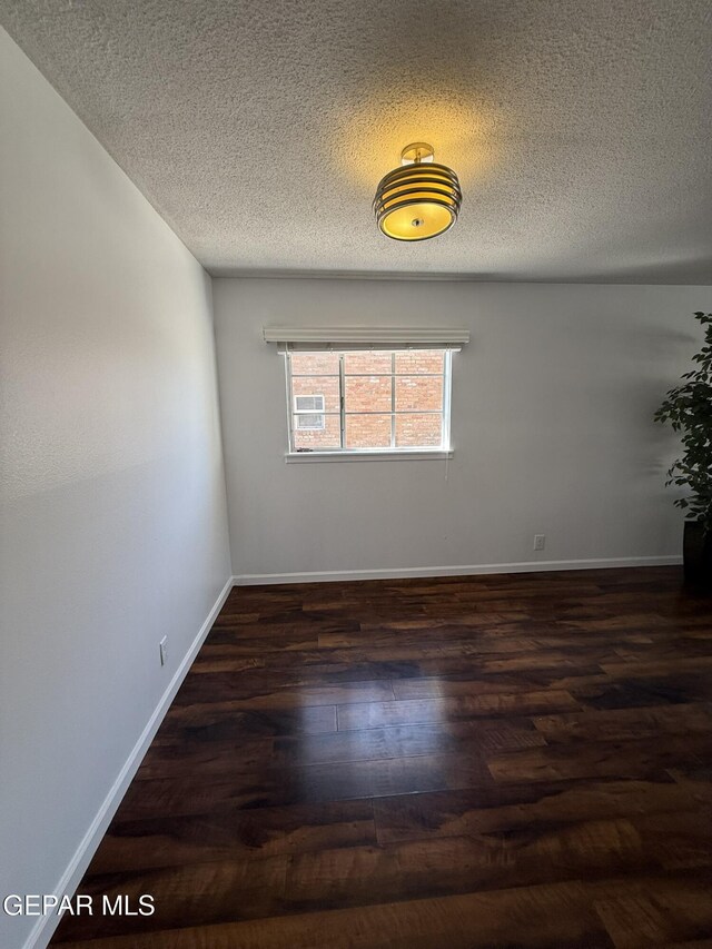6220 Bel Mar Ave, El Paso, TX 79912 - spare room with wood finished floors, a textured ceiling, and baseboards