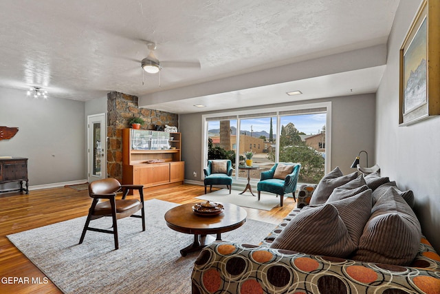 4012 Hastings Dr, El Paso, TX 79903 - living room with ceiling fan, light wood finished floors, baseboards, and a textured ceiling