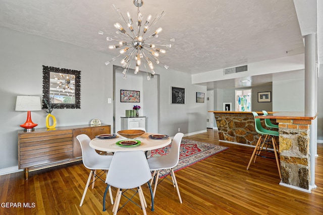 4012 Hastings Dr, El Paso, TX 79903 - dining area featuring hardwood / wood-style flooring, a chandelier, a textured ceiling, and baseboards