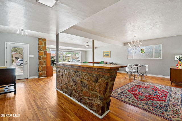 4012 Hastings Dr, El Paso, TX 79903 - kitchen with wood-type flooring, baseboards, a textured ceiling, a chandelier, and ceiling fan