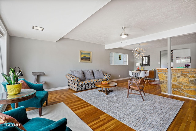 4012 Hastings Dr, El Paso, TX 79903 - living area with baseboards, wood finished floors, a chandelier, and a textured ceiling