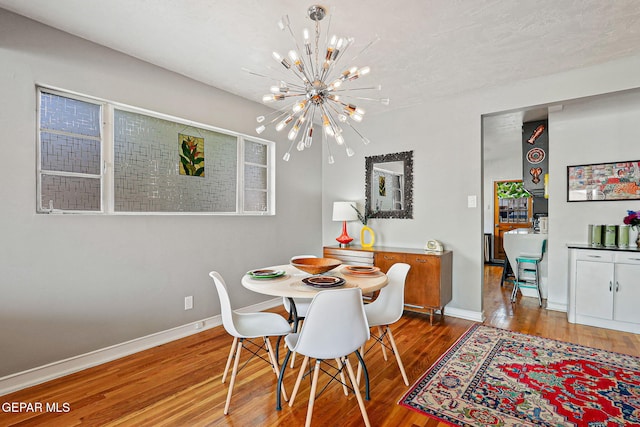4012 Hastings Dr, El Paso, TX 79903 - dining room with a chandelier, wood finished floors, and baseboards