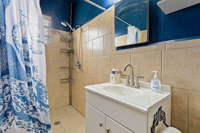 4012 Hastings Dr, El Paso, TX 79903 - bathroom with tile walls, vanity, a tile shower, and tile patterned flooring