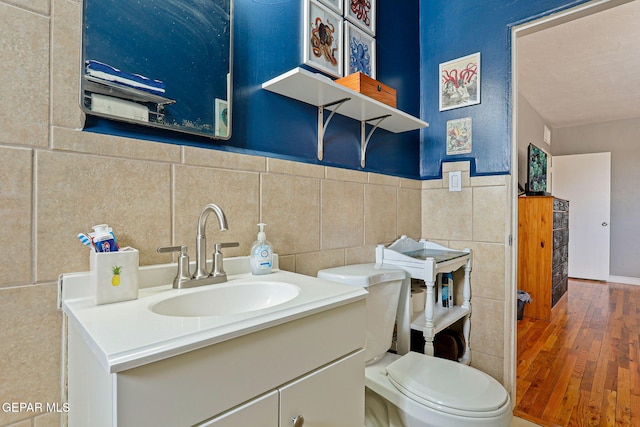 4012 Hastings Dr, El Paso, TX 79903 - half bath with vanity, hardwood / wood-style floors, toilet, and tile walls