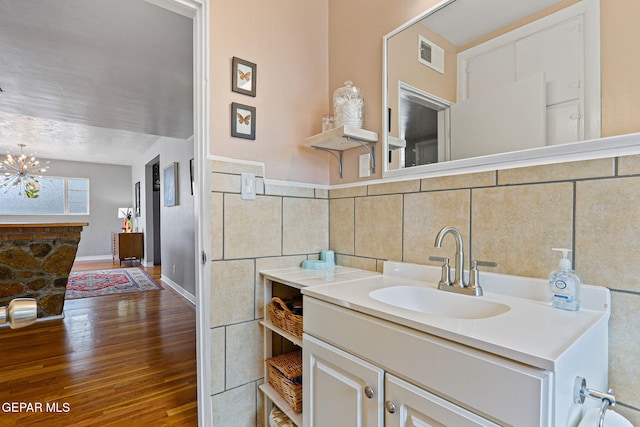 4012 Hastings Dr, El Paso, TX 79903 - bathroom with hardwood / wood-style floors, a chandelier, vanity, and baseboards