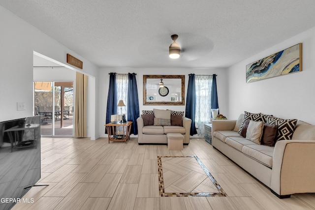 532 Gentry Way, El Paso, TX 79928 - living area featuring a textured ceiling, ceiling fan, and light wood-type flooring