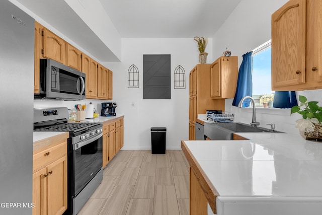 532 Gentry Way, El Paso, TX 79928 - kitchen featuring stainless steel appliances, a sink, light countertops, baseboards, and a peninsula