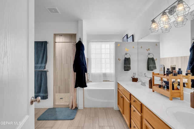 532 Gentry Way, El Paso, TX 79928 - bathroom featuring a bath, double vanity, and tiled shower