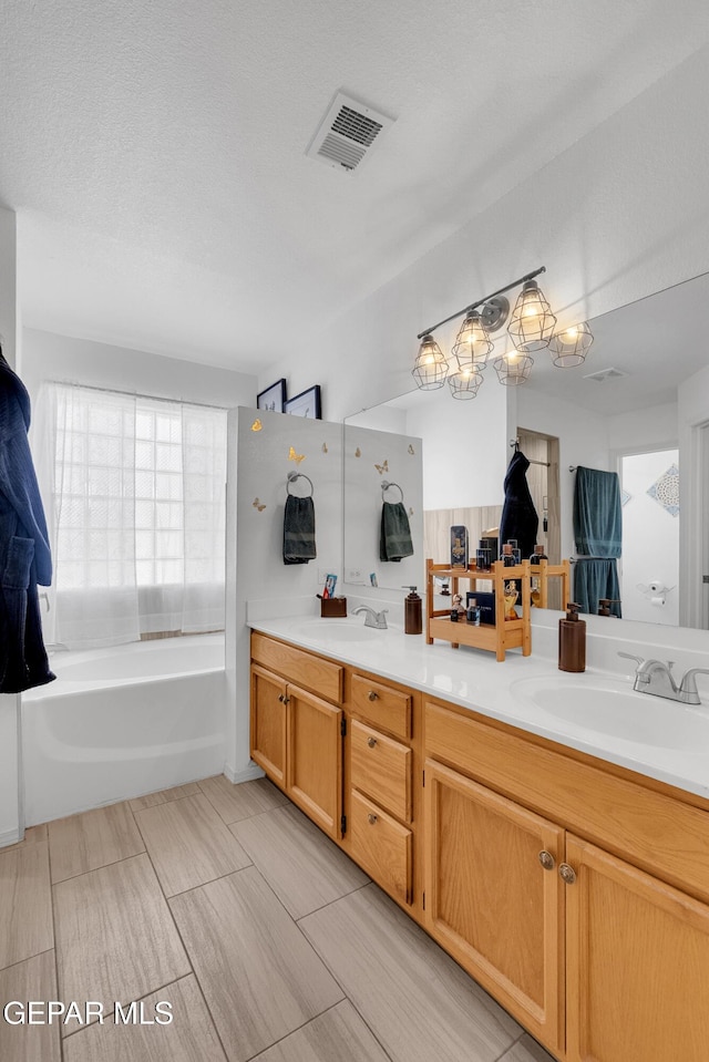 532 Gentry Way, El Paso, TX 79928 - bathroom featuring double vanity and a tub to relax in