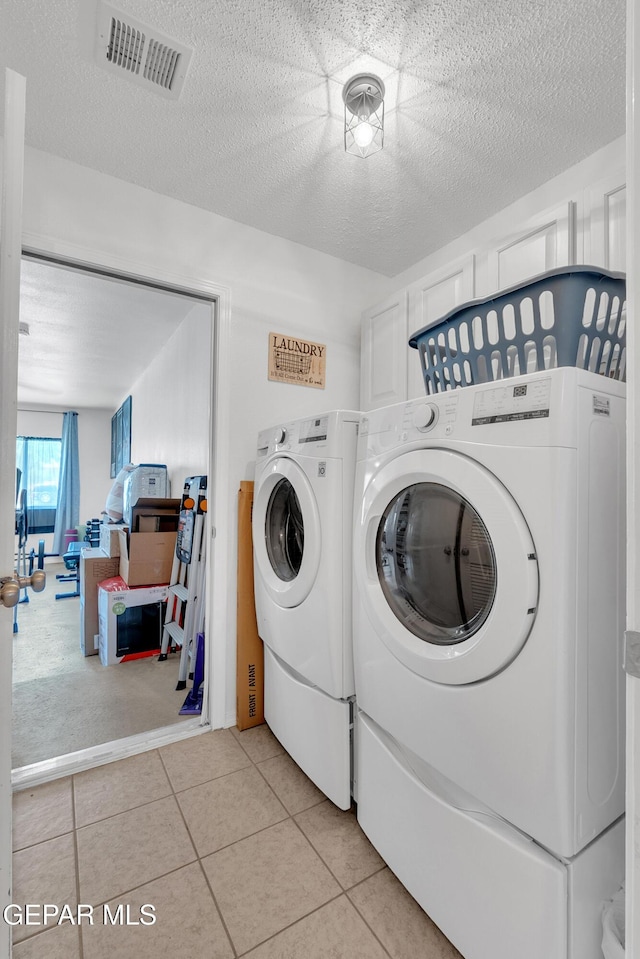 532 Gentry Way, El Paso, TX 79928 - laundry room with separate washer and dryer, light tile patterned floors, and a textured ceiling